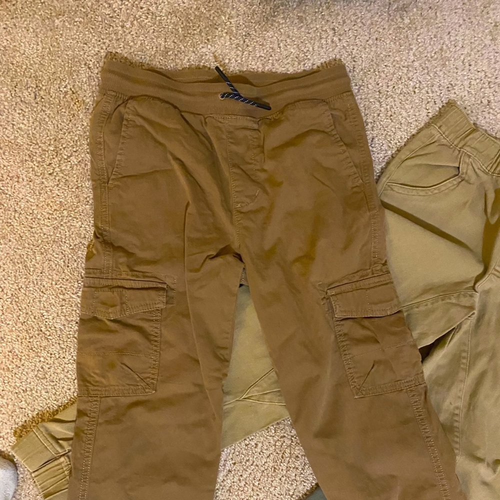 Black dockers are size 28. Tan khaki school threads size m 10-12 elastic waist